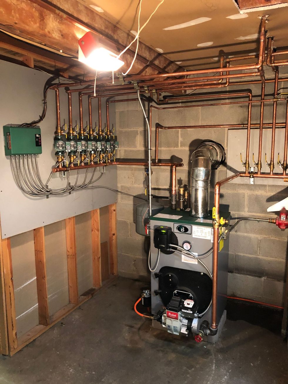 Air conditioning units with toolbox and gloves in backyard.