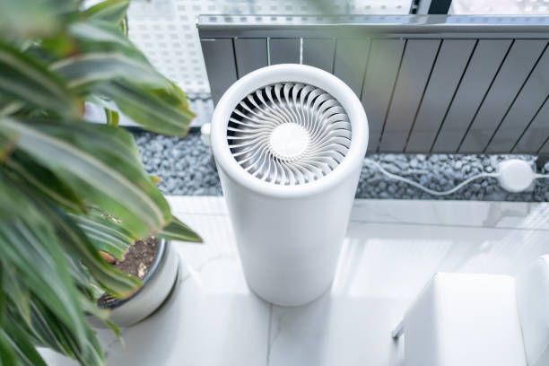 Air conditioning units with toolbox and gloves in backyard.