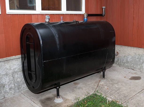 Air conditioning units with toolbox and gloves in backyard.