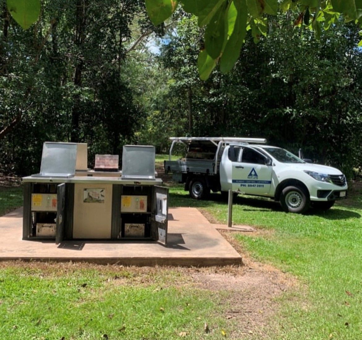 A ute is parked in a park near a BBQ — Ausplumb NT in Palmerston, NT
