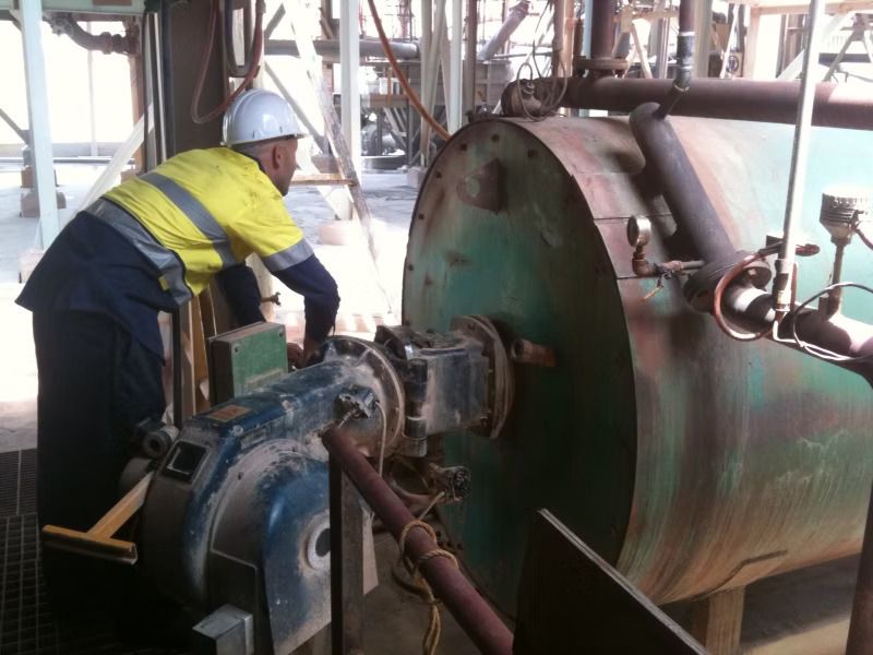 A Man is Working on a Pipe at a factory — Ausplumb NT in Winnellie, NT

