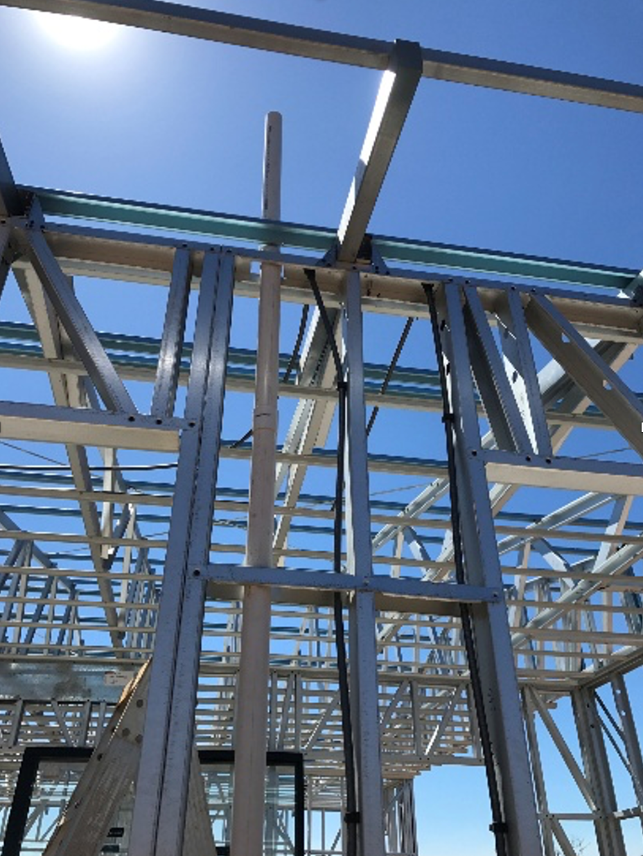 Metal house frame construction against a blue sky. — Ausplumb NT in Palmerston, NT