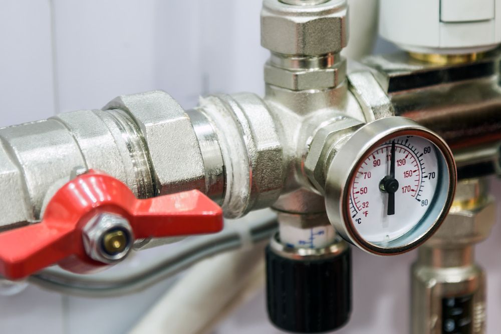 A Close Up of a Valve and a Pressure Gauge on a Pipe — Ausplumb NT in Winnellie, NT