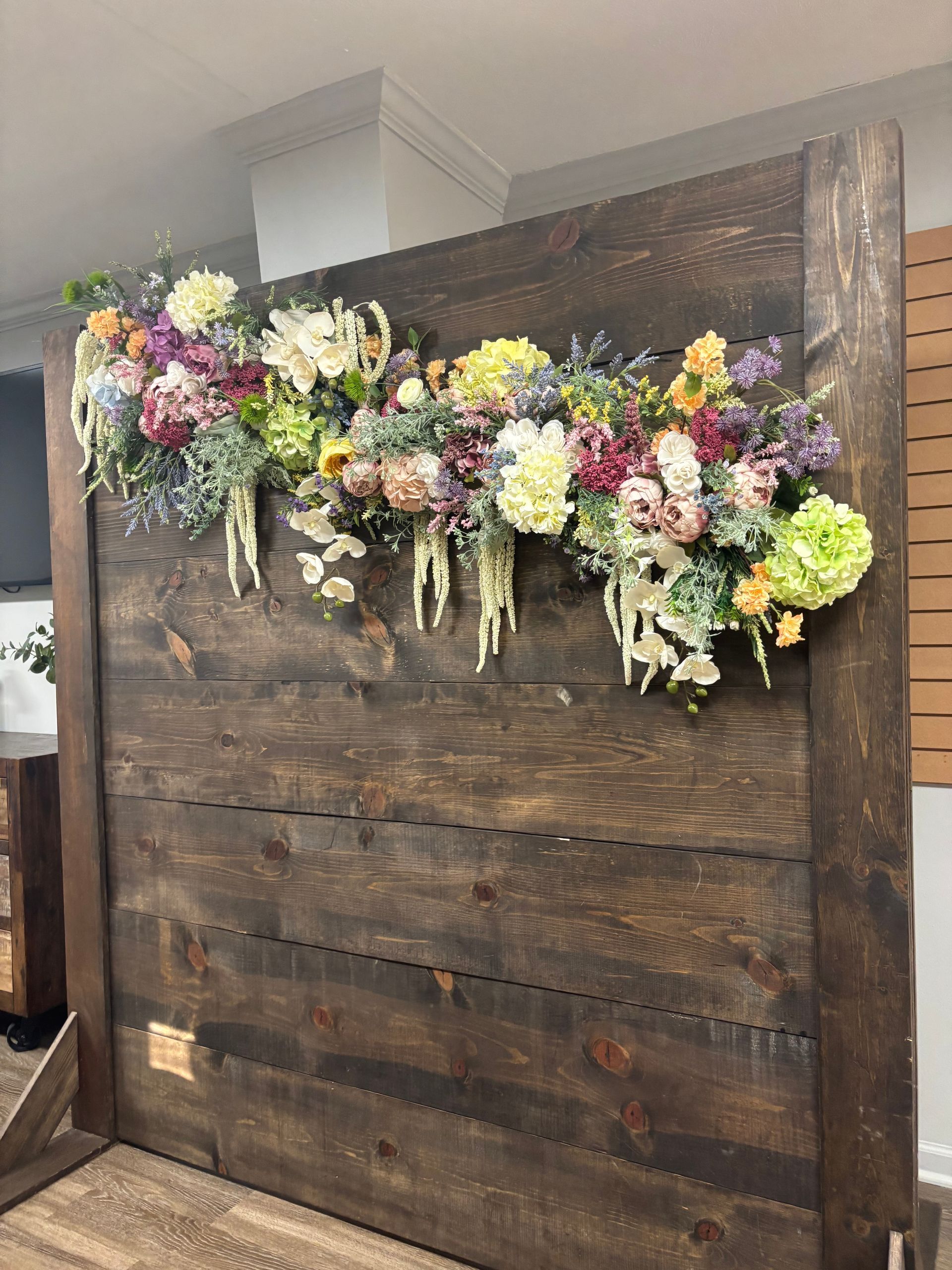 wooden photo backdrop with colorful flowers