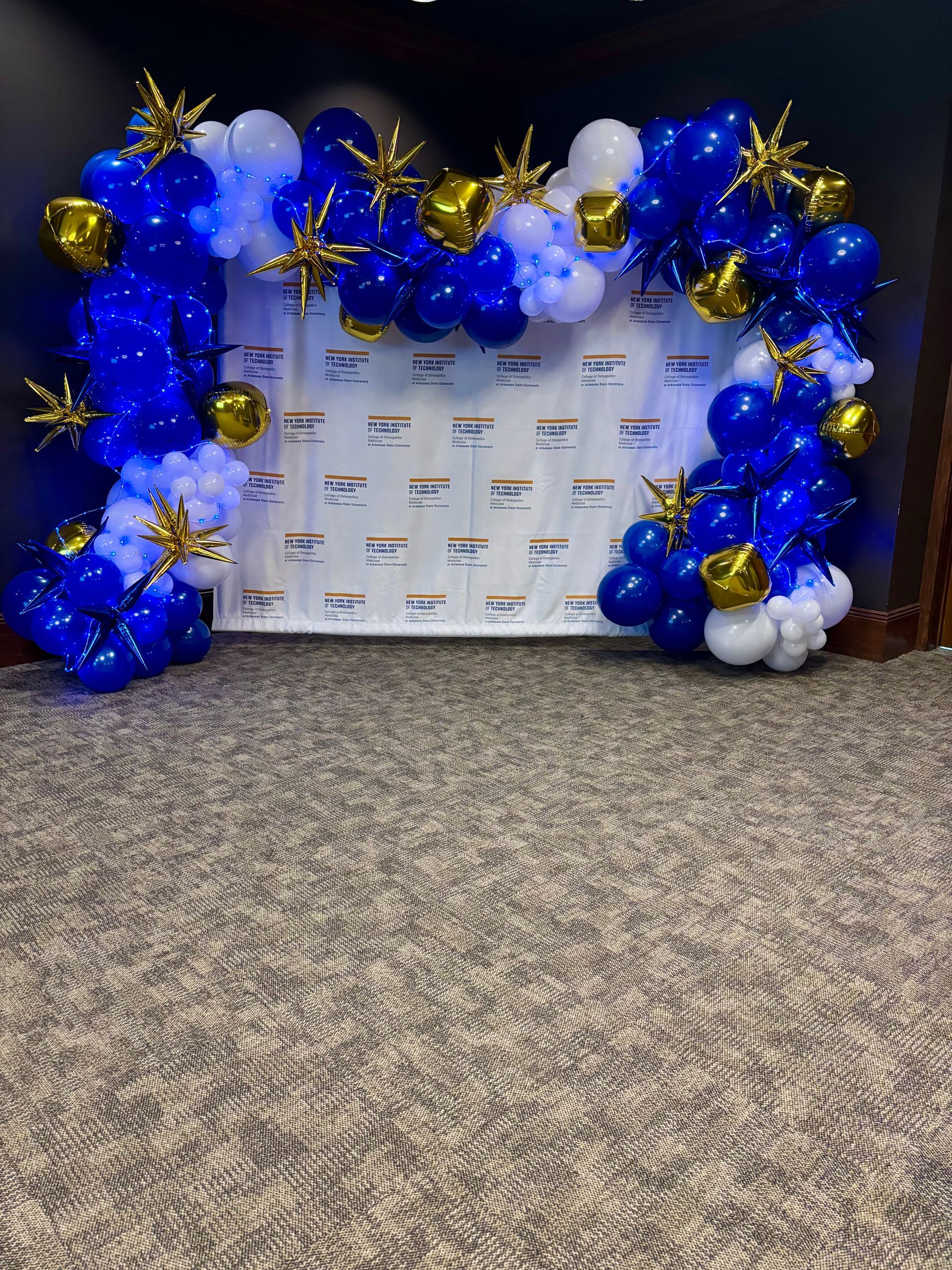 blue, gold, and white balloon arch photo backdrop