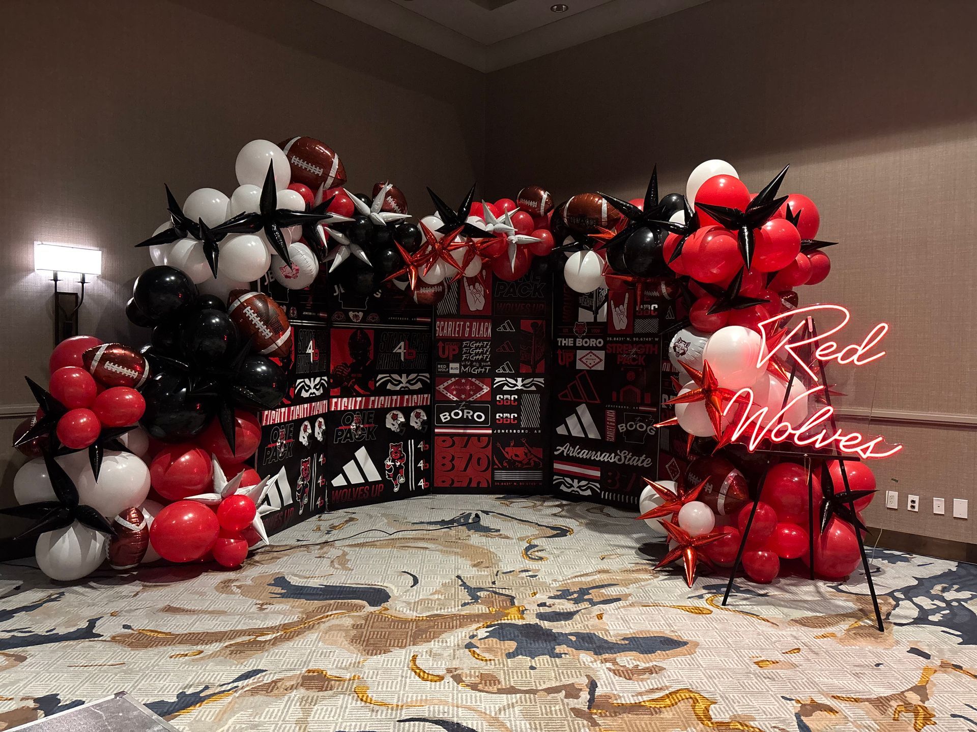 black and red balloon decor for arkansas state athletic event