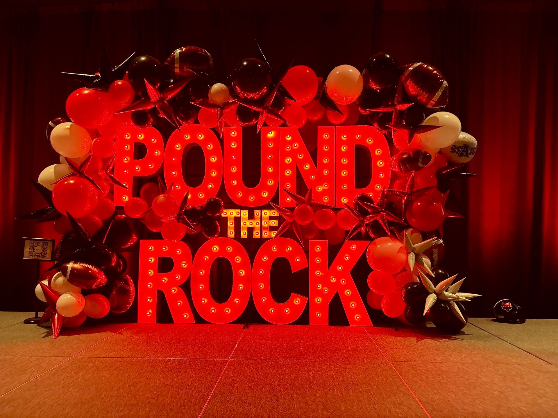 balloon arch surrounding marquee letters