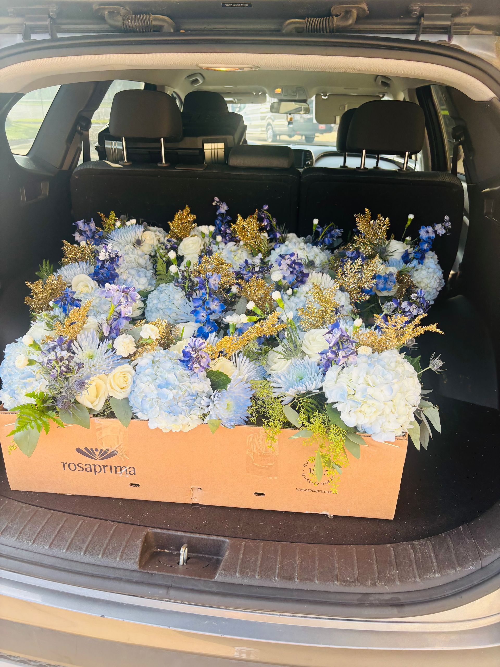 large blue, white, and gold floral arrangement