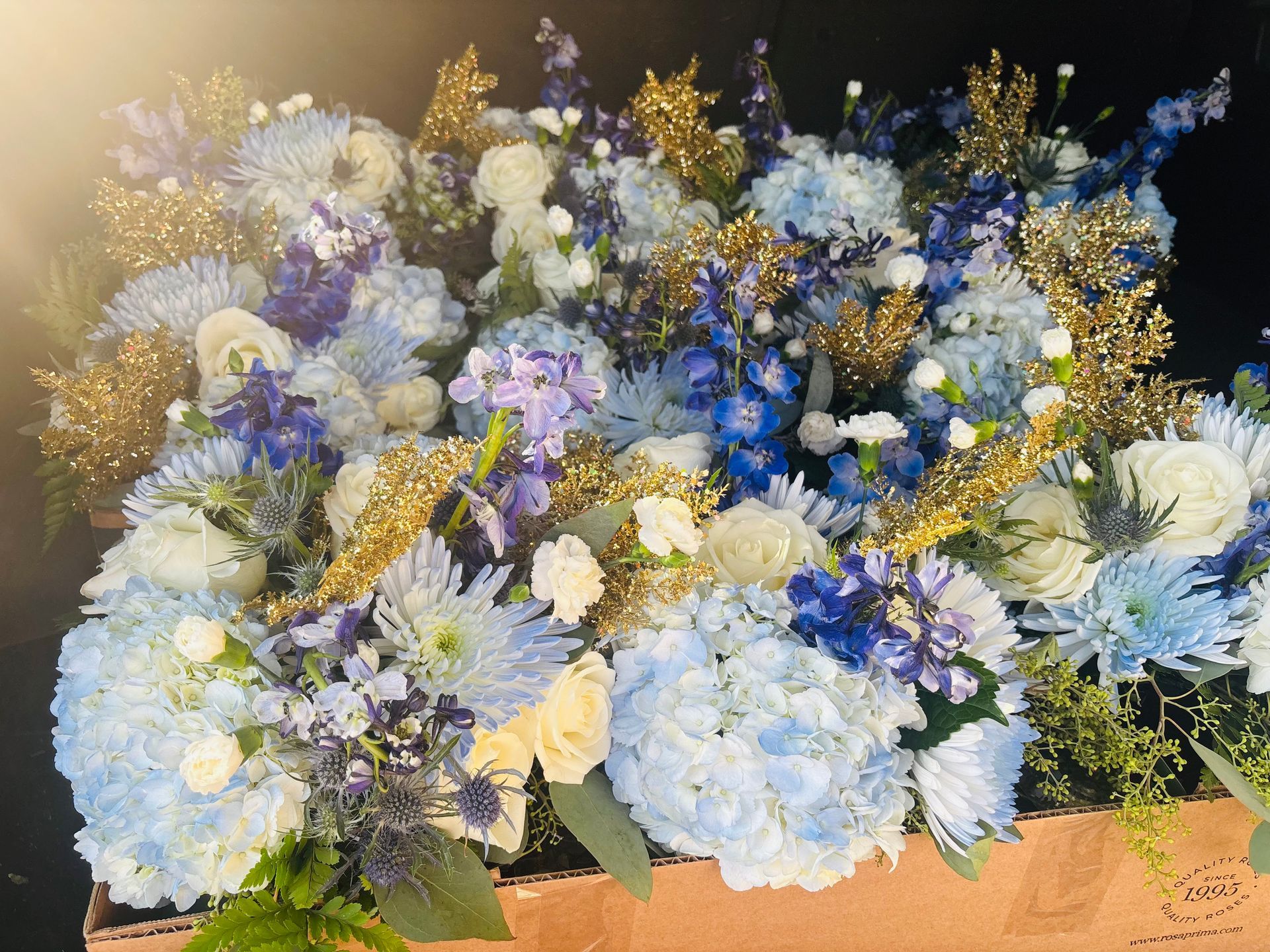 blue flower arrangement with gold accents