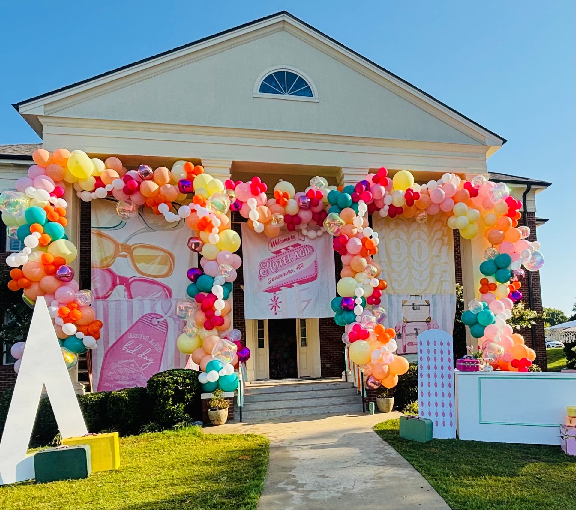 large colorful balloon arches on sorority building