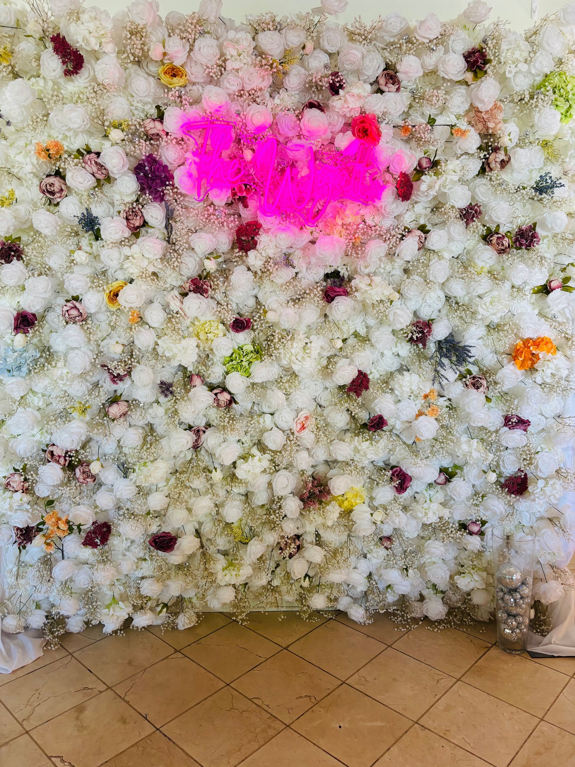 floral backdrop with pink neon light