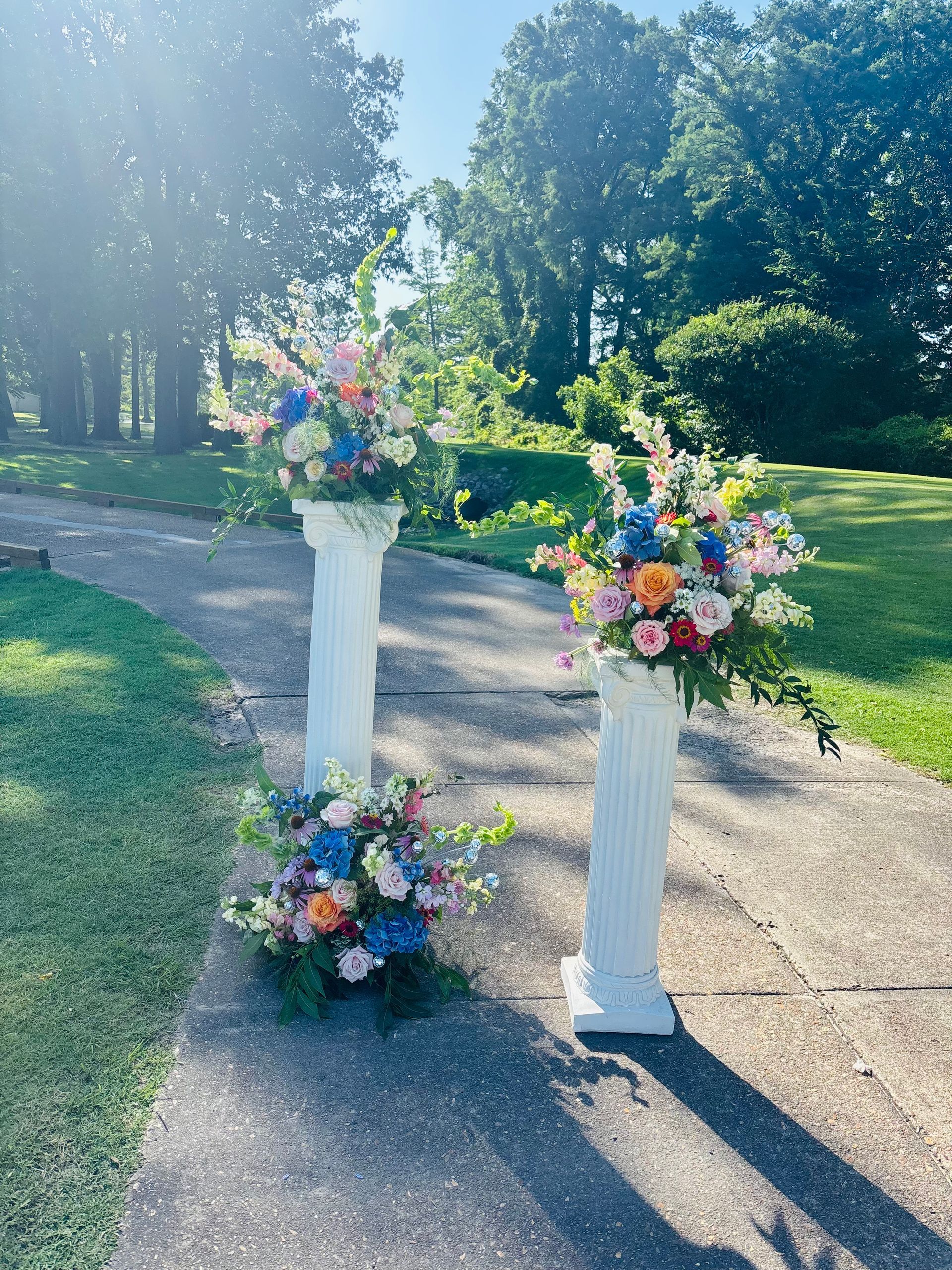 colorful wedding flowers on white columns