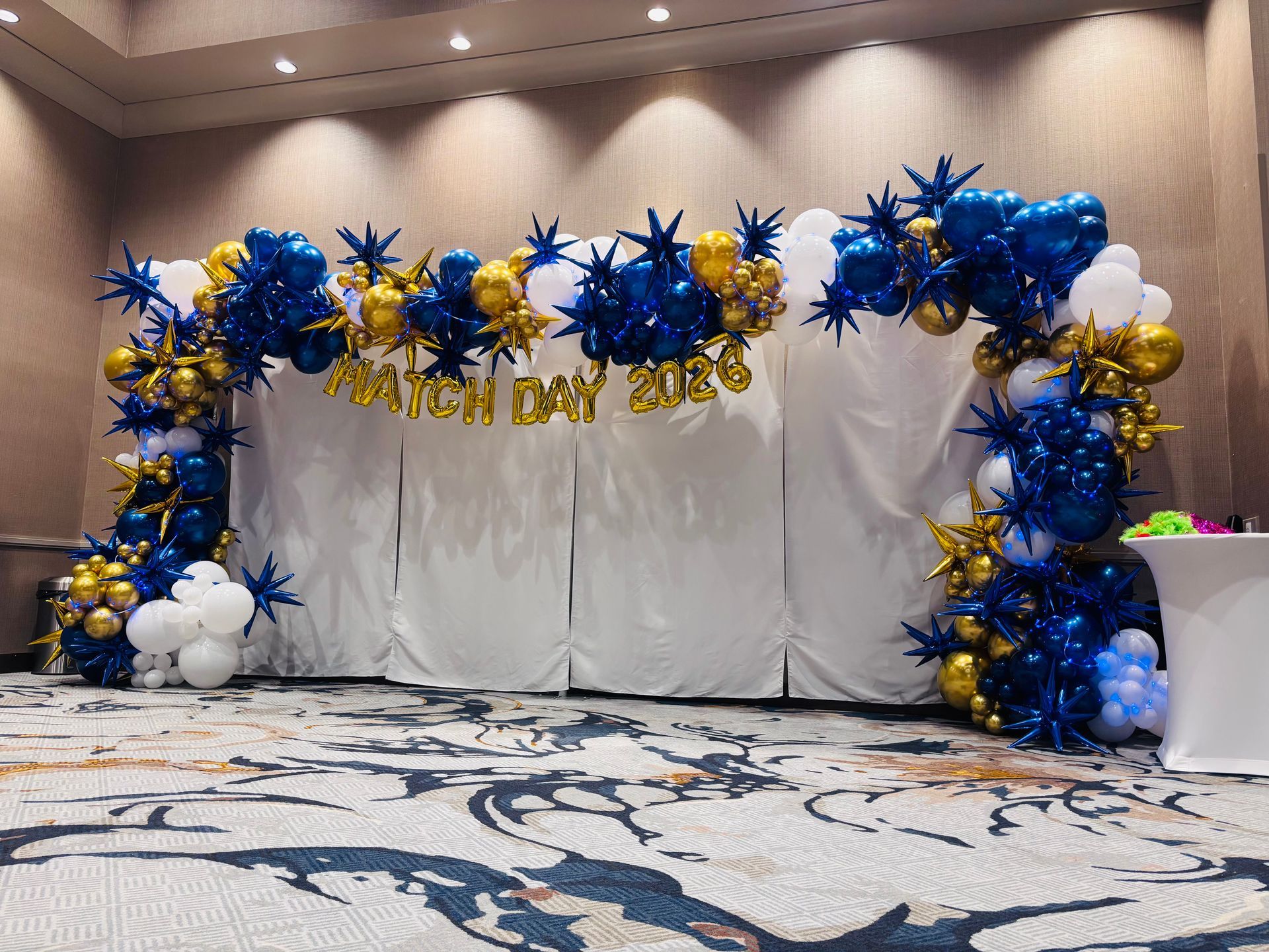 large blue and gold balloon arch for school event