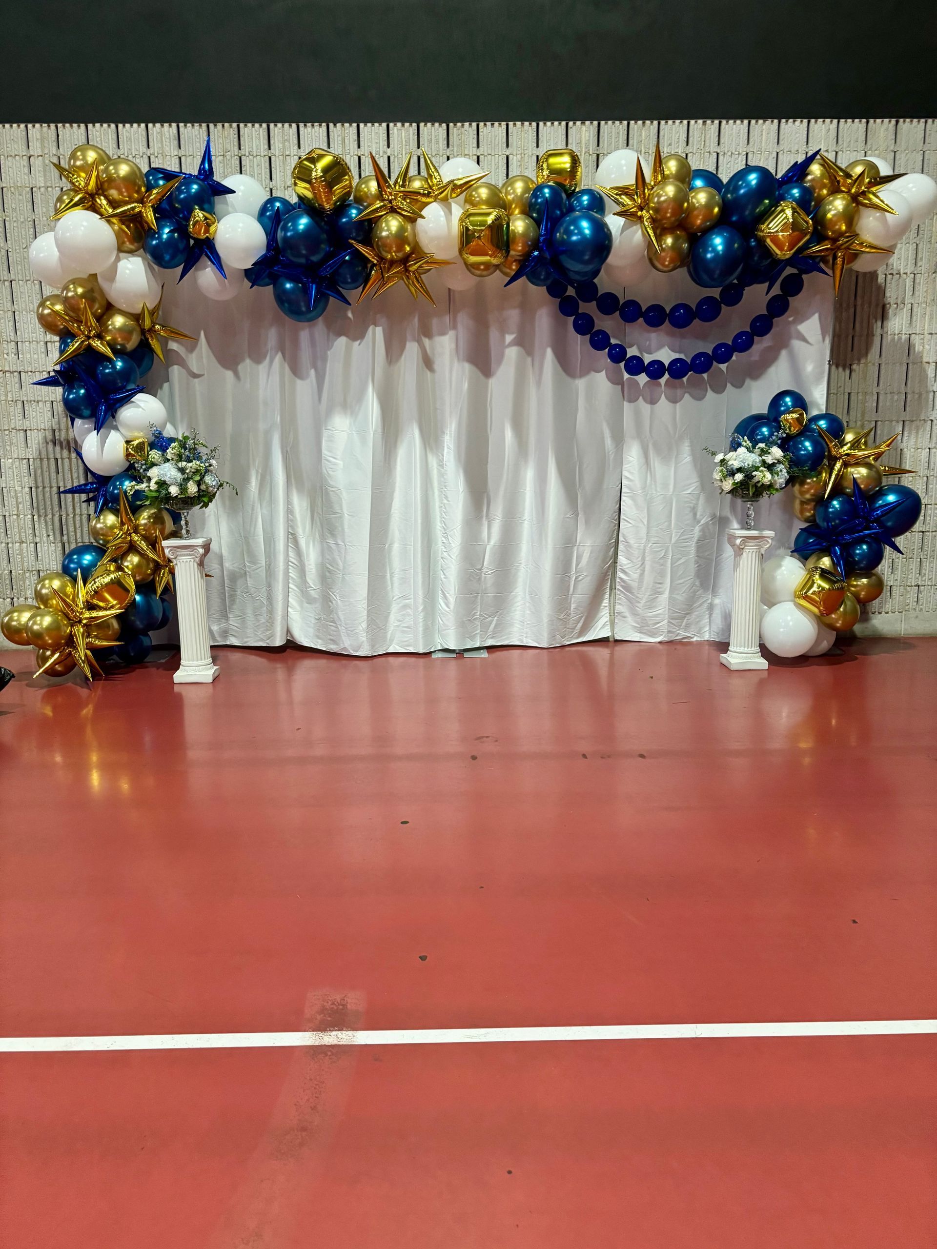 large gold and blue balloon arch