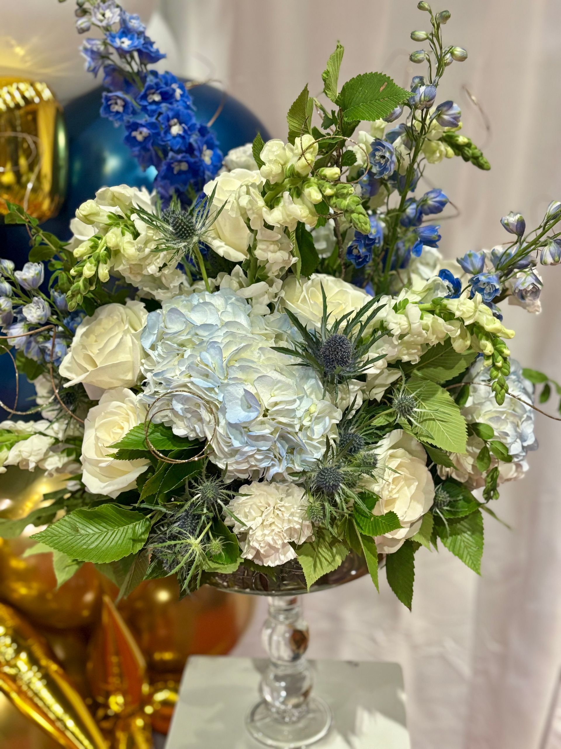 floral arrangement with blue hydrangeas and white roses