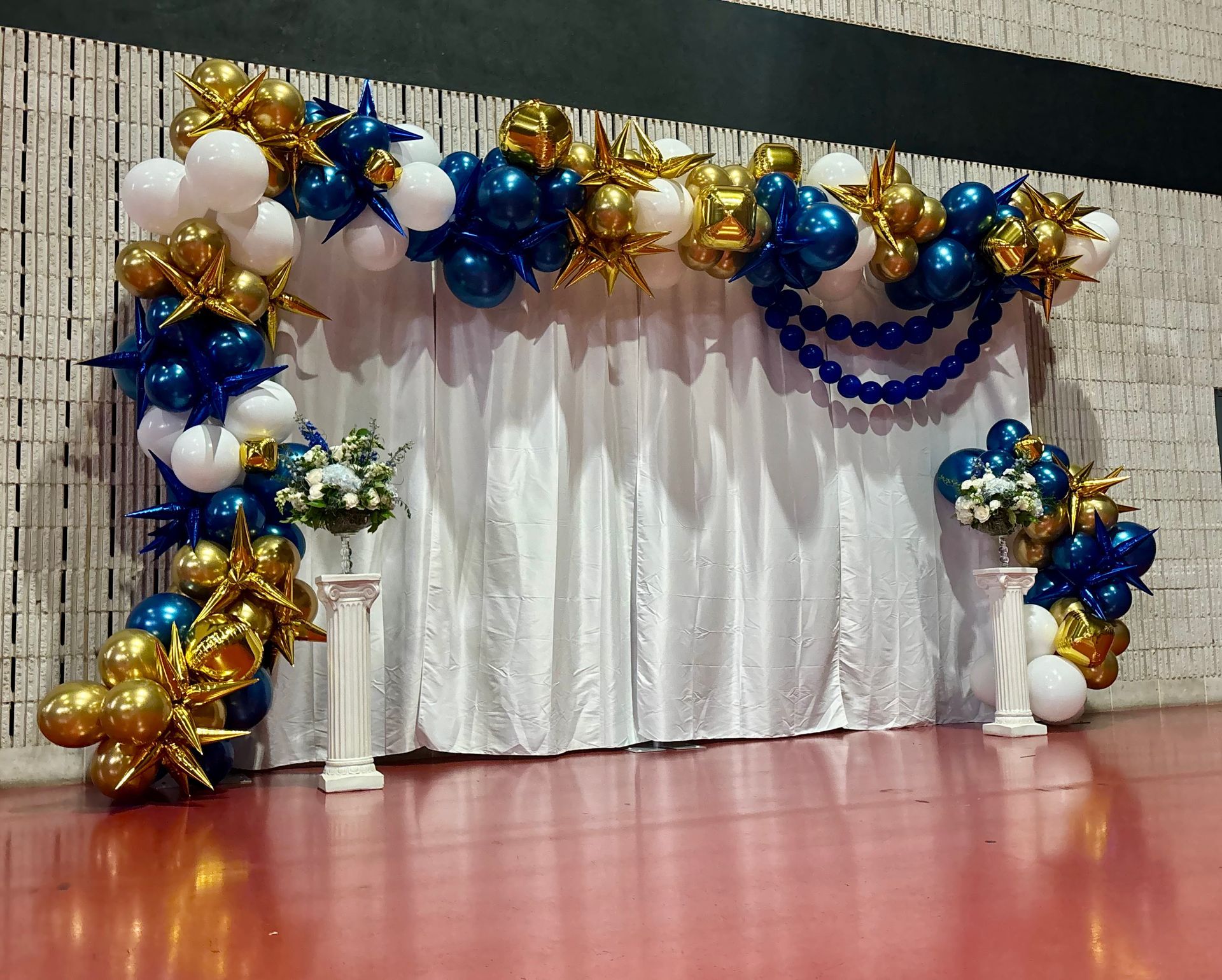 blue and gold balloon arch