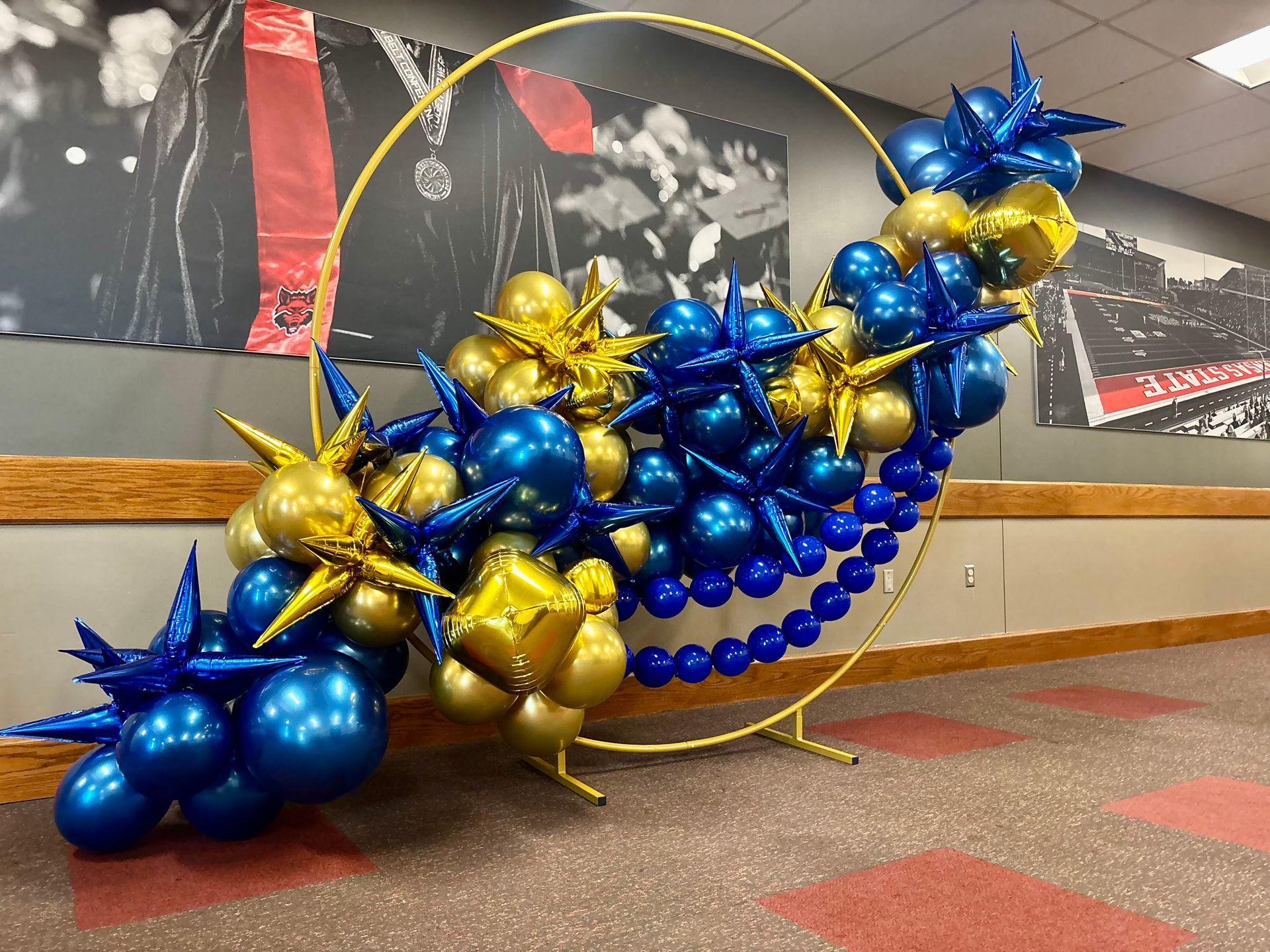 gold arch with blue and gold balloons