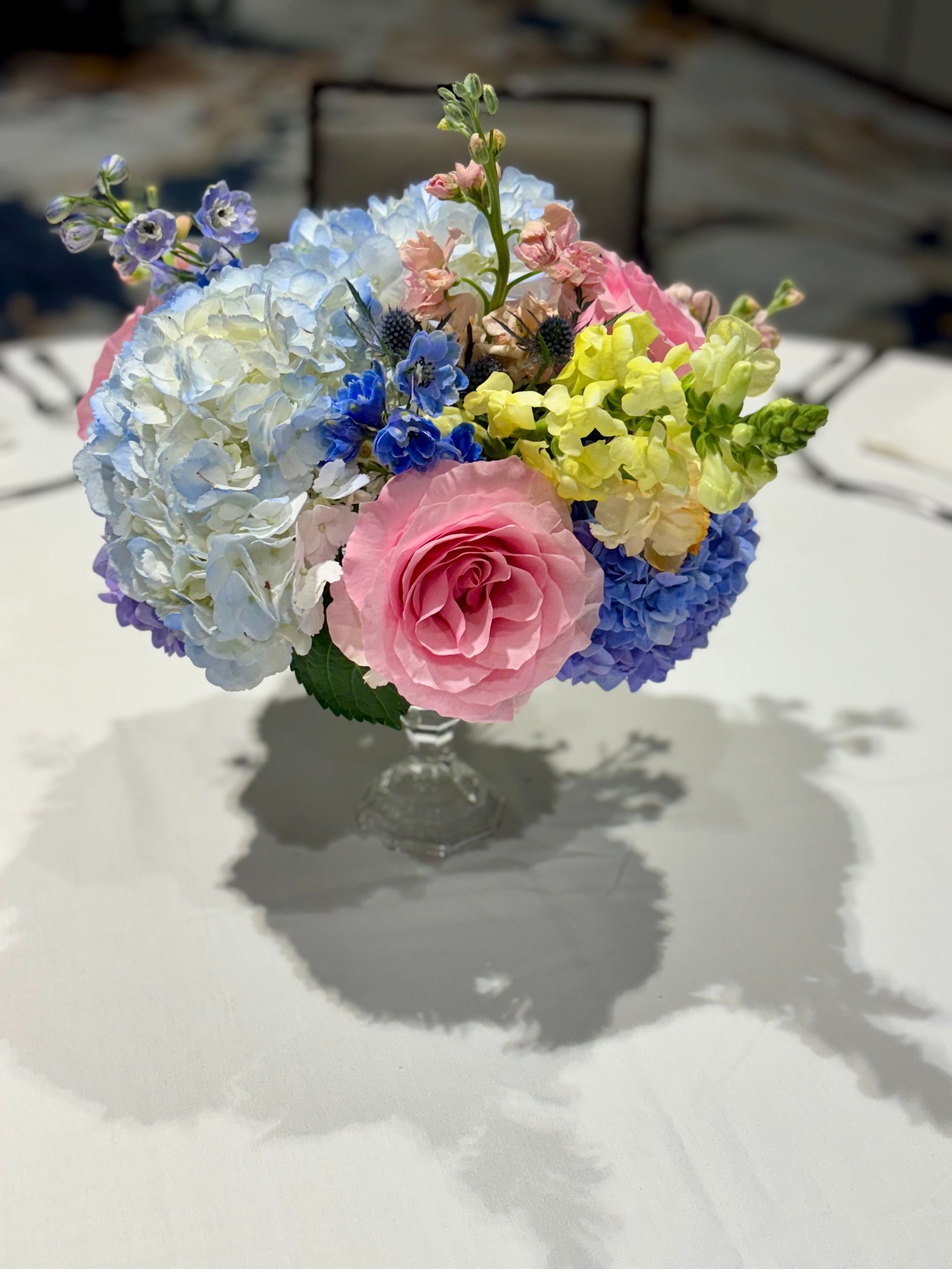 spring pink, blue, and yellow floral arrangement