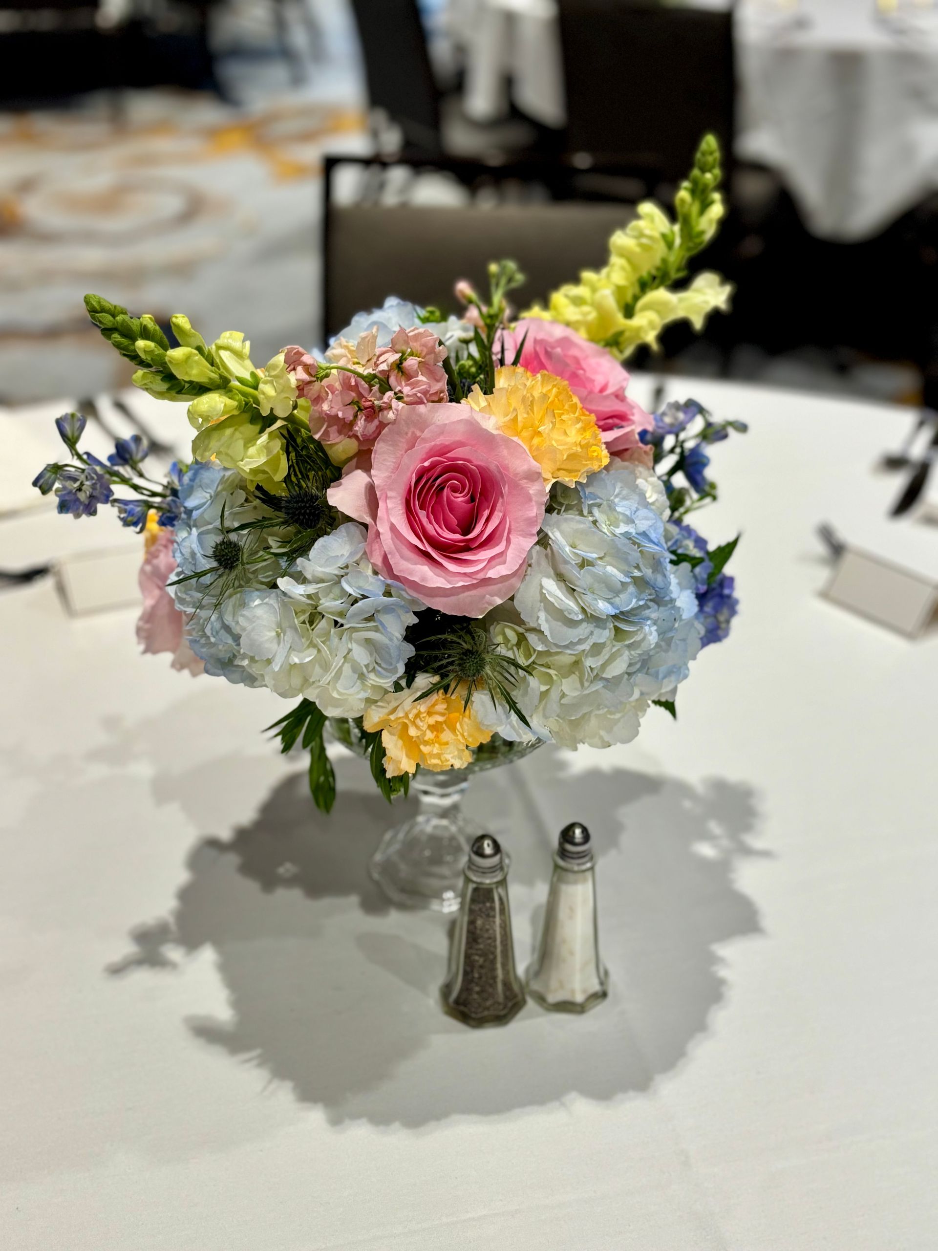 spring pink, blue, and yellow floral arrangement