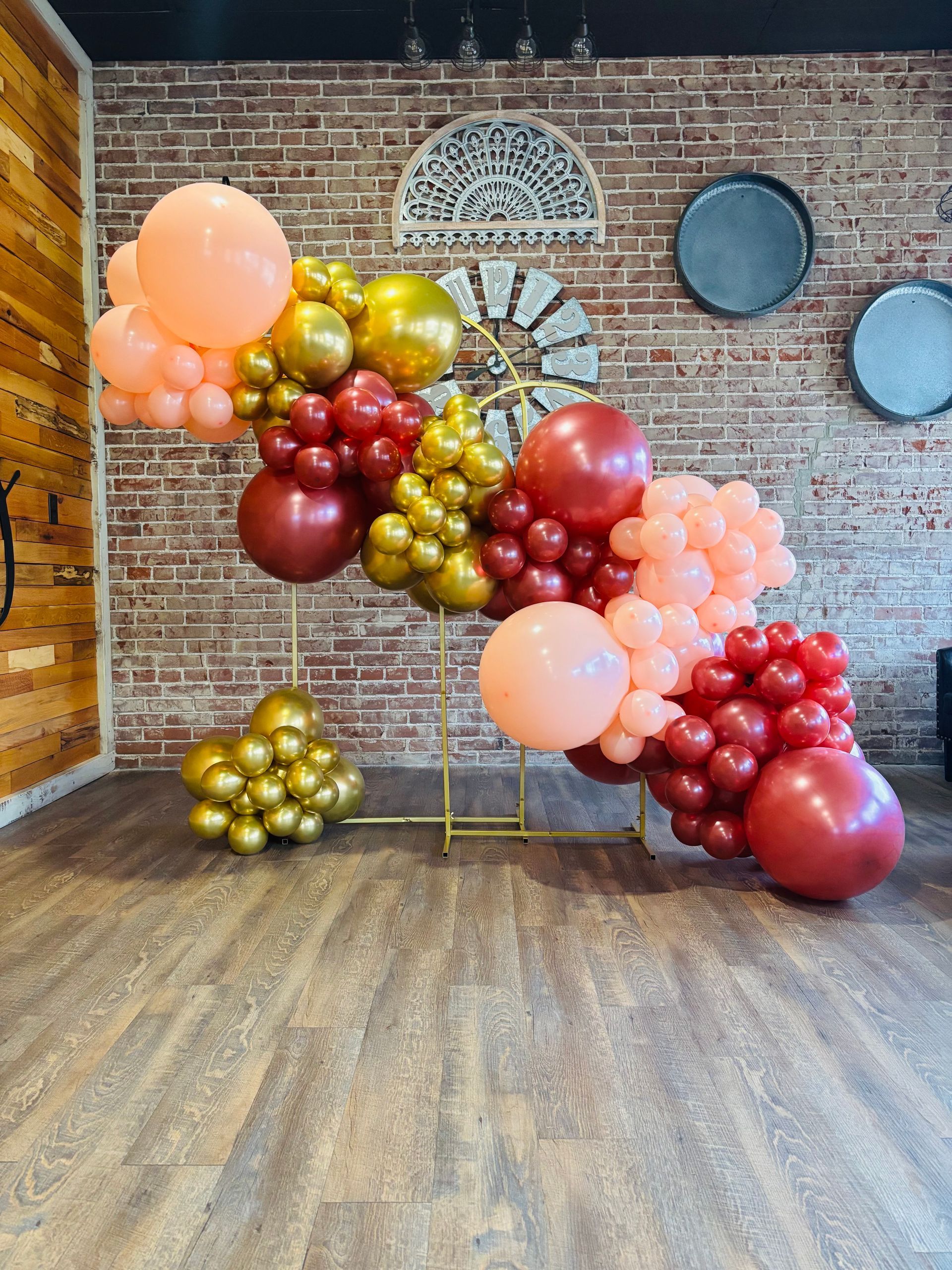 peach, red, and gold balloon column