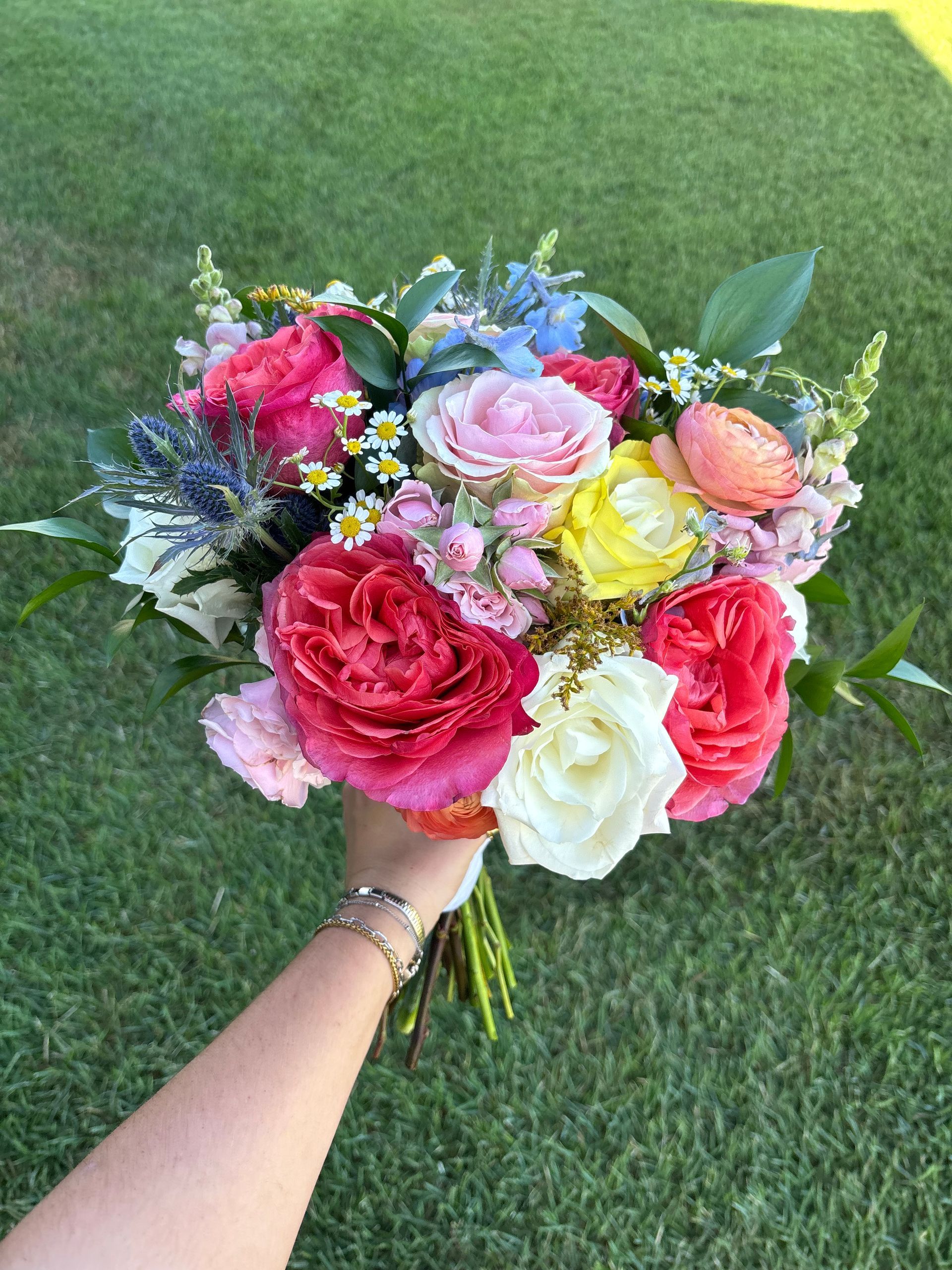 colorful pink, orange, peach, and yellow flower arrangement