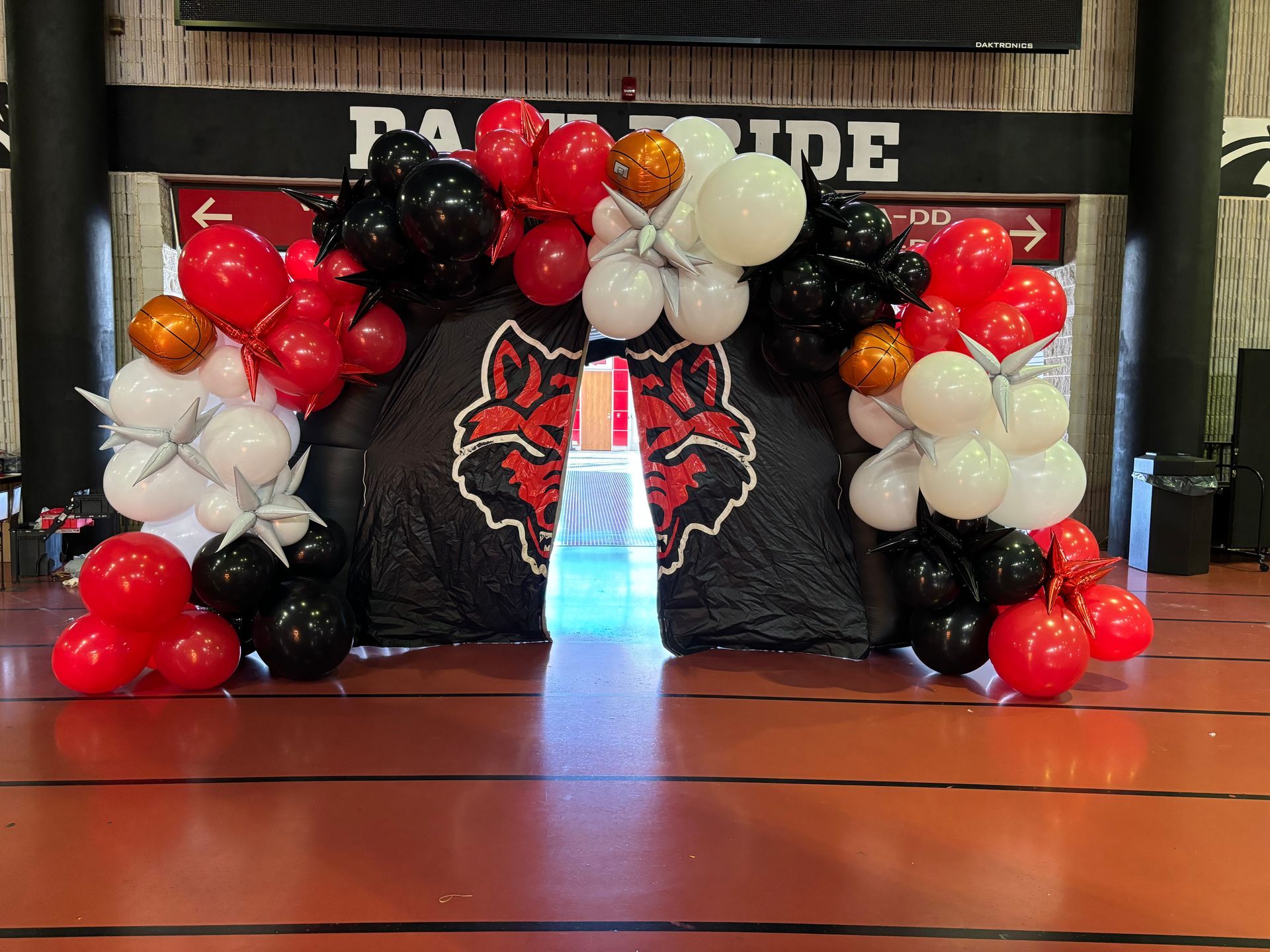 red and black balloon arch for school athletic event