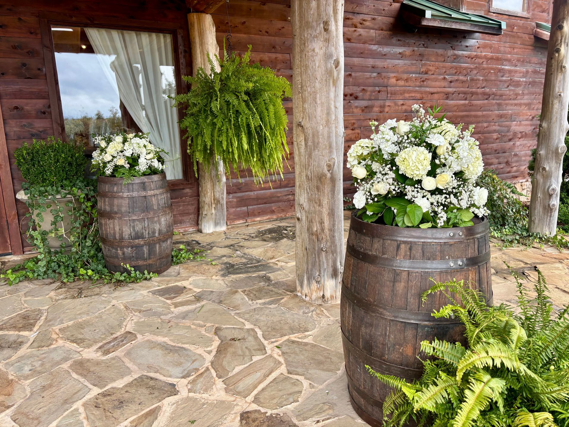wedding flowers on whiskey barrels