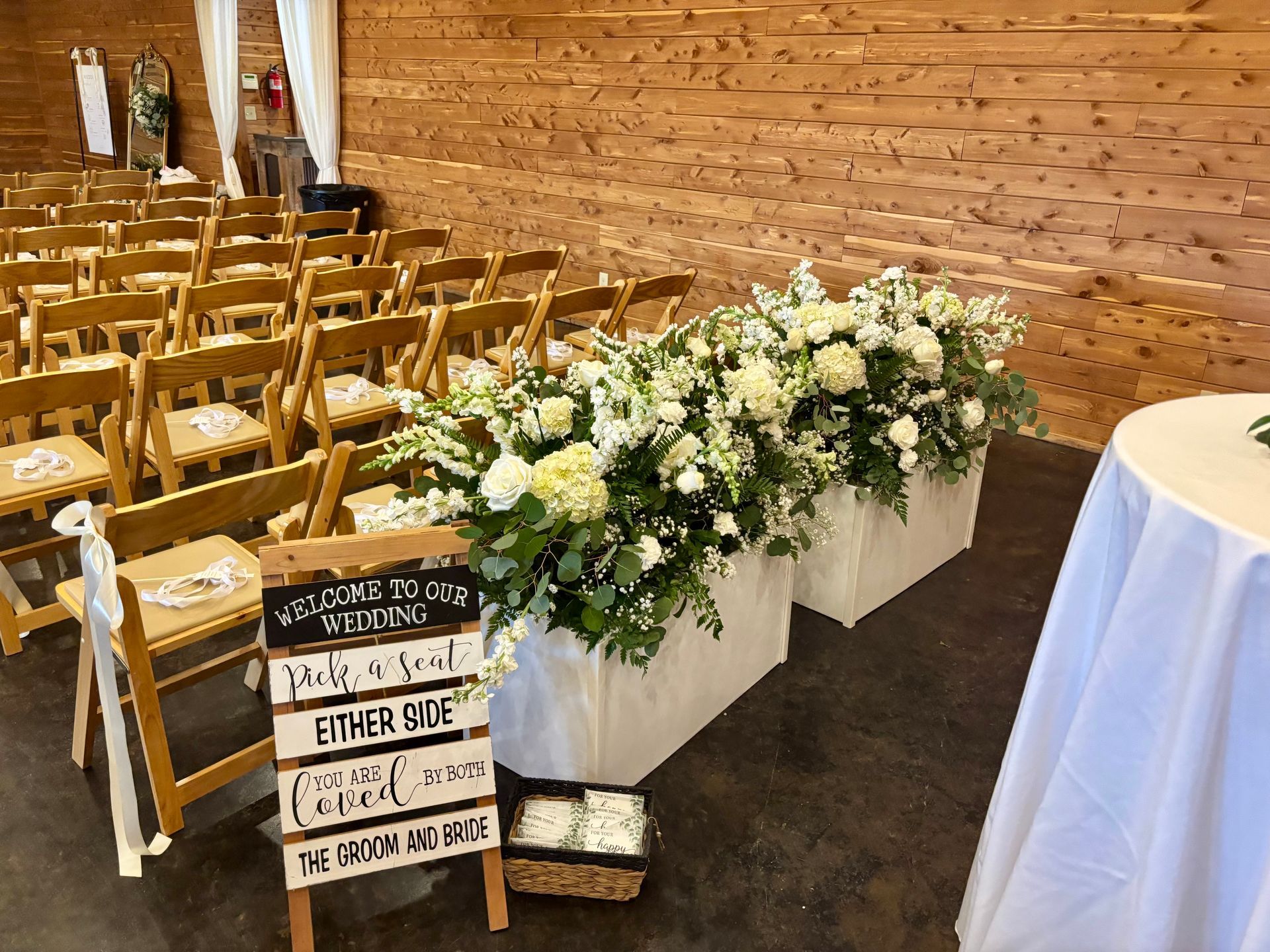 large white wedding floral arrangements with greenery