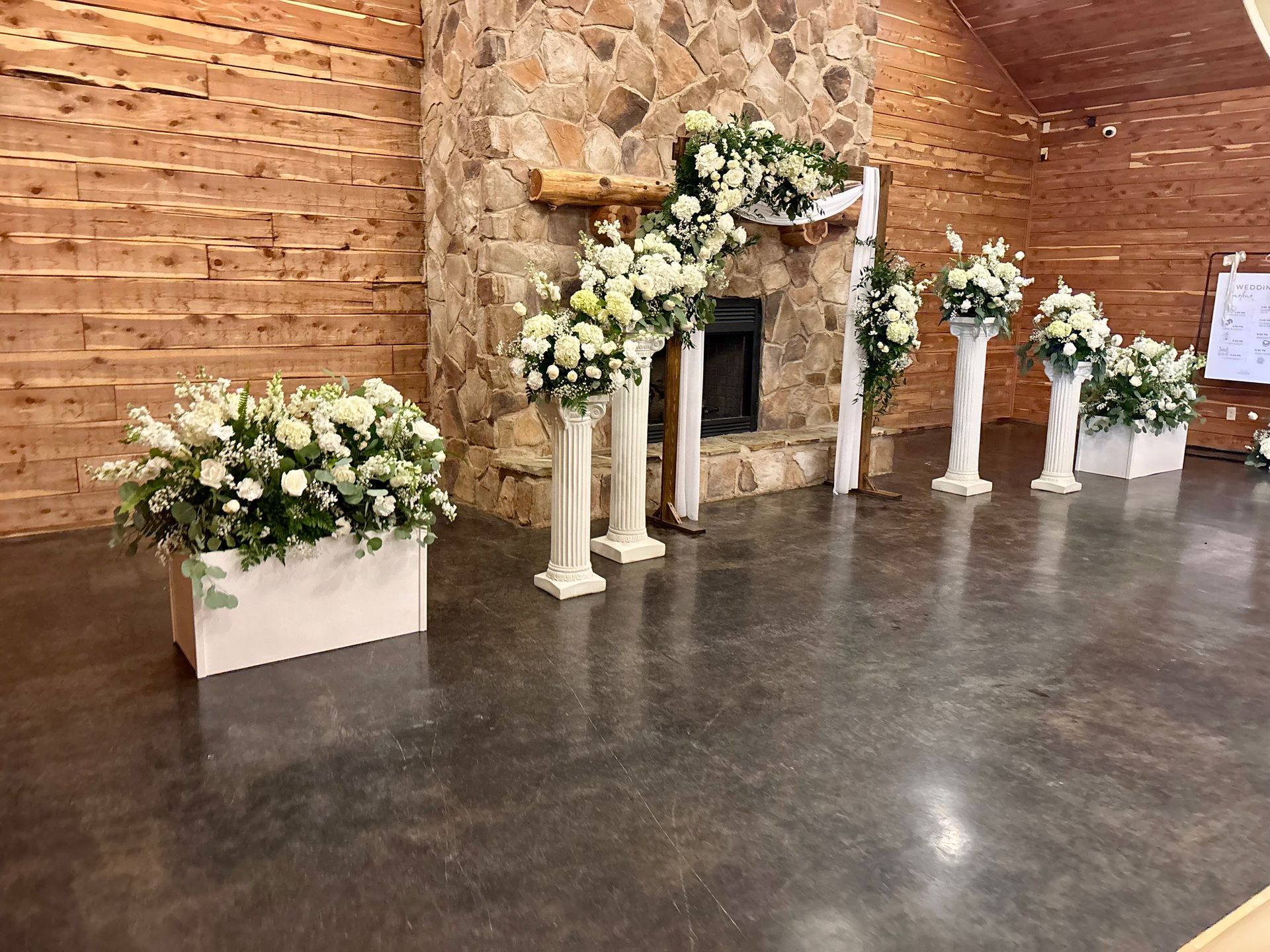 all white and greenery wedding ceremony flowers