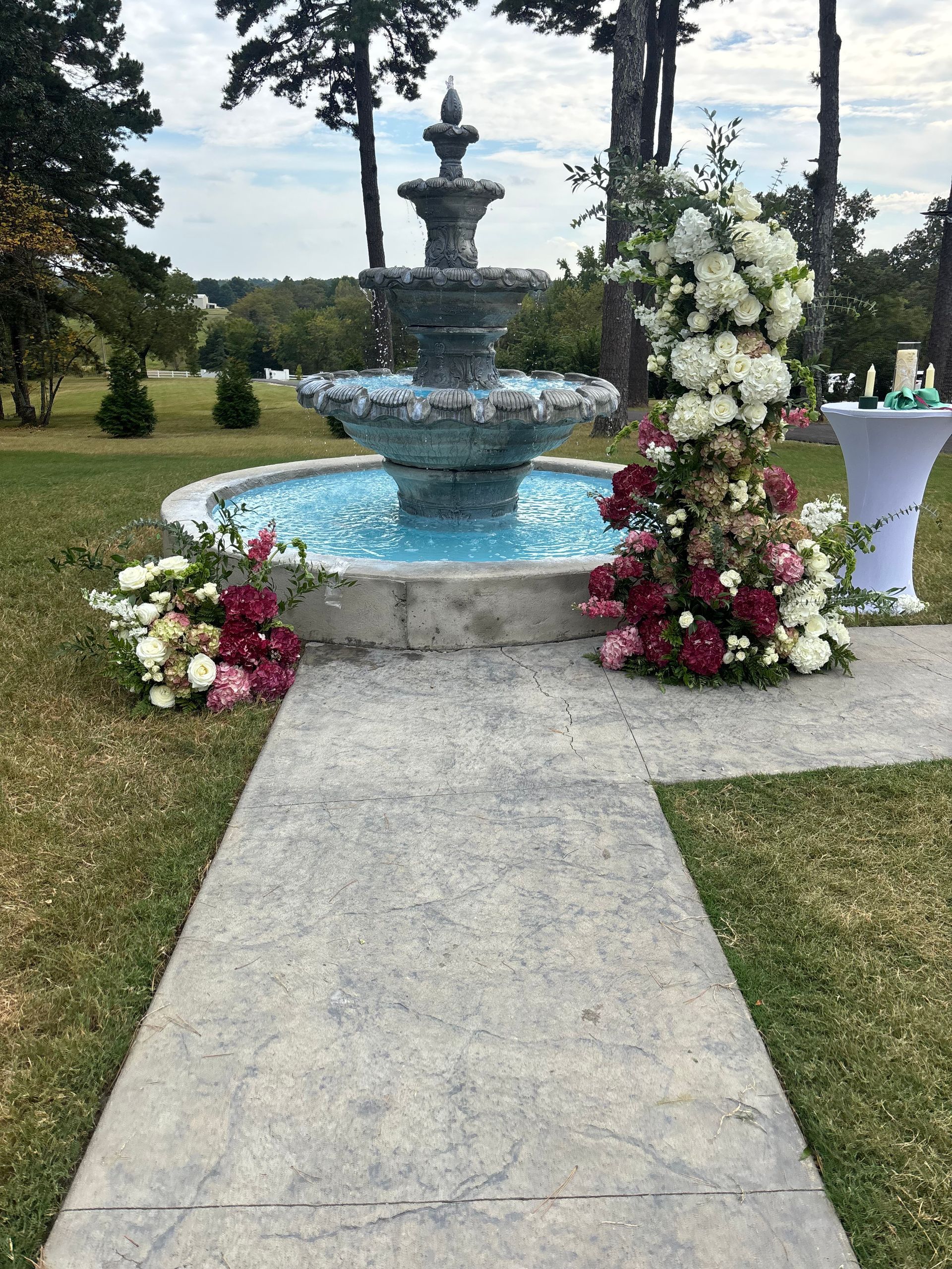 wedding flowers surrounding outdoor fountain