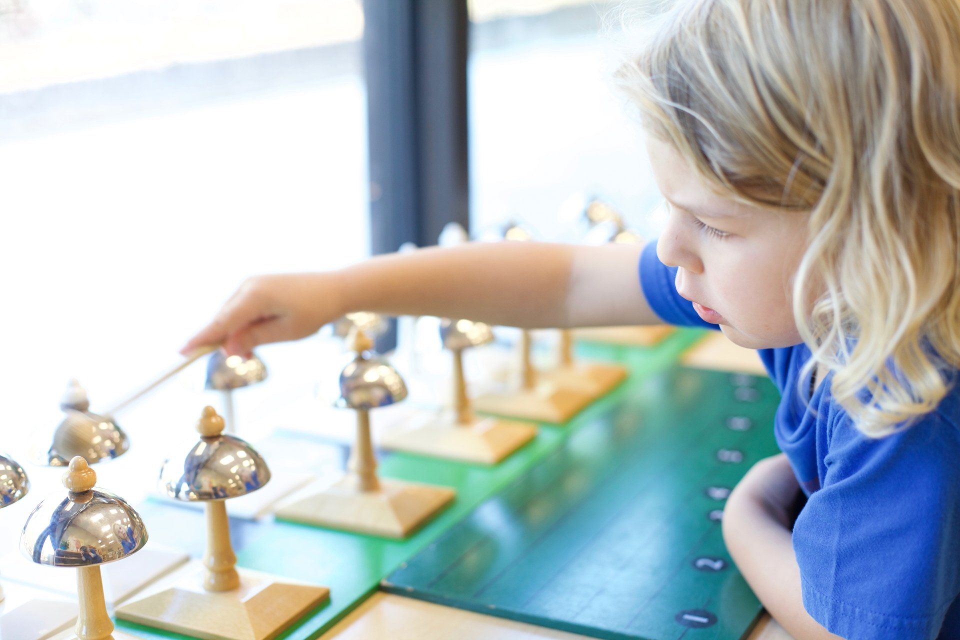 Montessori child playing a musical instrument