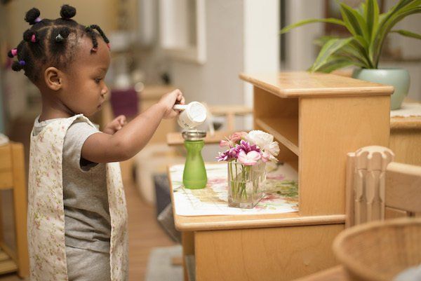 Child working with Montessori practical life materials