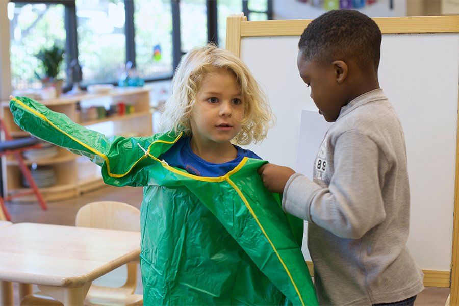 Child helping Montessori classmate