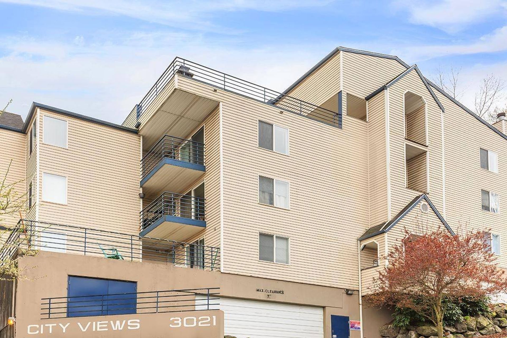 Beige apartment building with balconies and blue accents, labeled City View.
