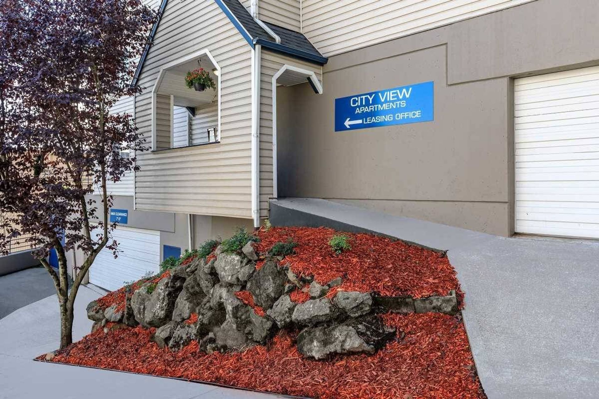 City View apartments sign beside a landscaped rock bed and garage entrance.