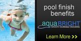 a little girl is swimming underwater in a pool .