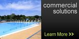 a large swimming pool with a sign that says commercial solutions learn more .