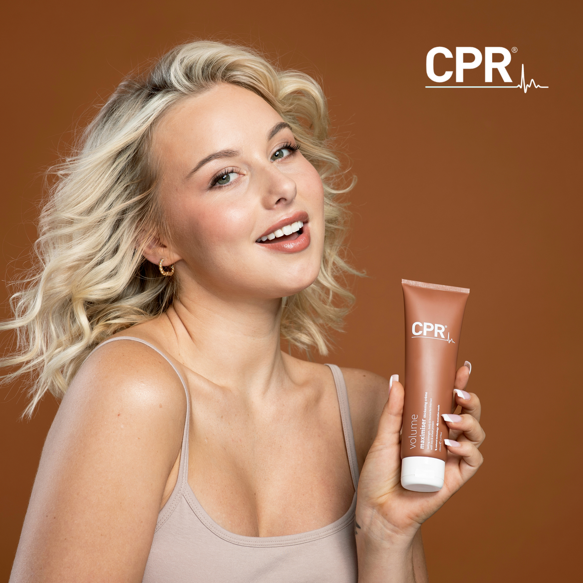 Blonde Girl Holding Product - Hair Creations in Blackalls Park, NSW