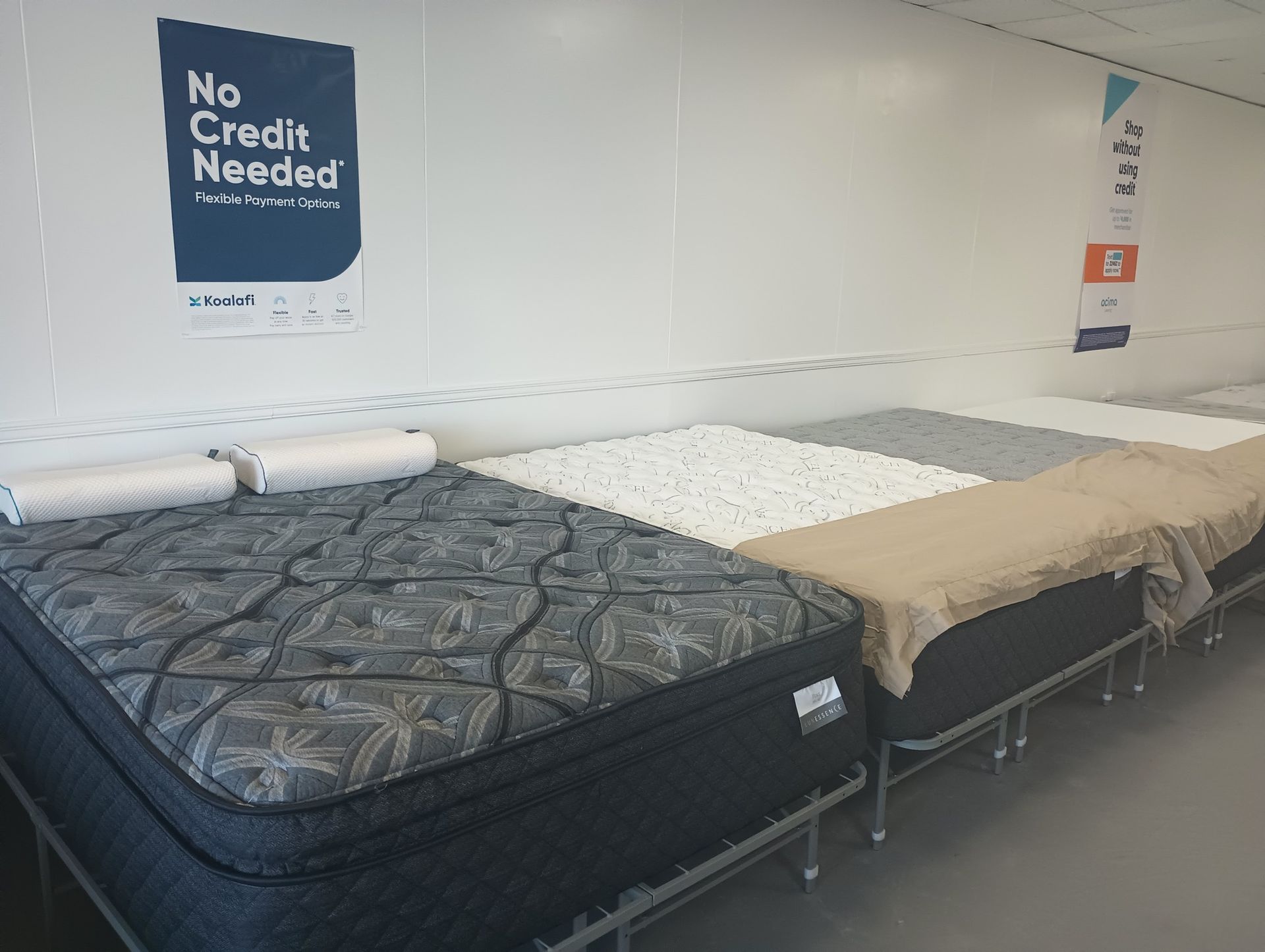 Mattresses on display in a store, several styles visible, with 