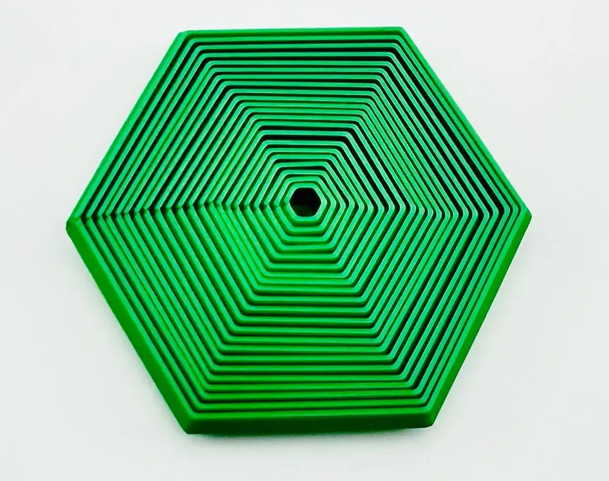 Green hexagonal layered geometric shape on a white background