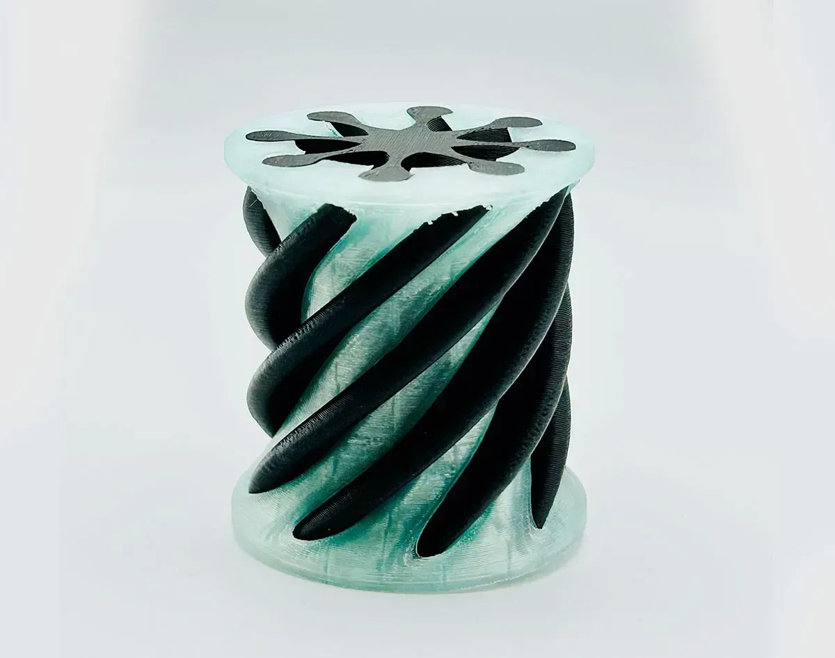 Black spiral twist sculpture with pale blue accents on a white background