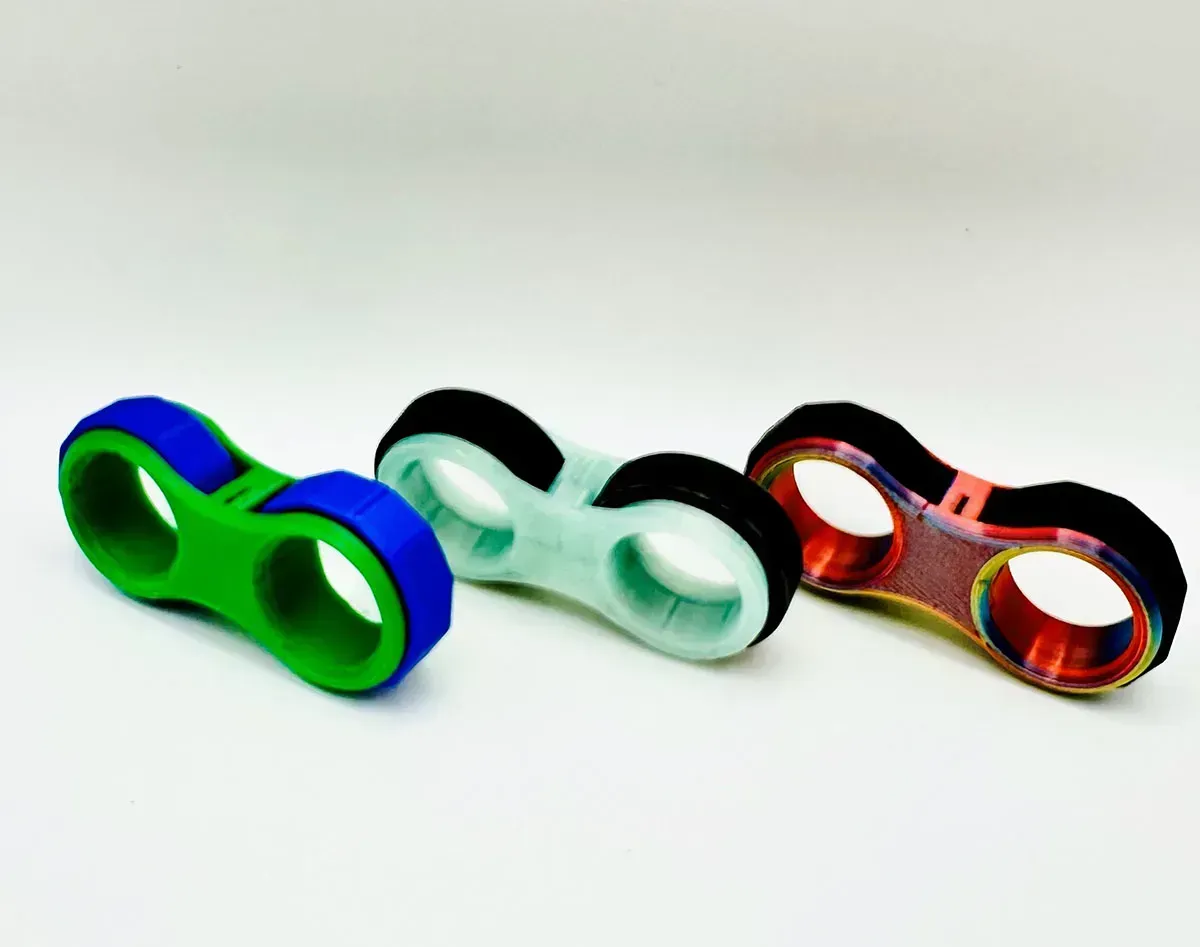 Three colorful double-loop fidget toys on a white background