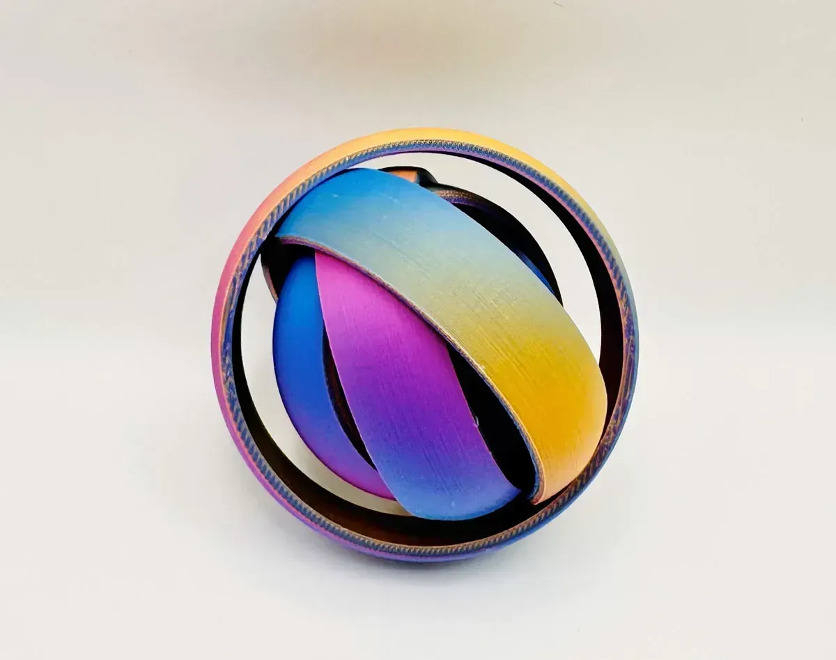 Abstract colorful circular logo with blue, purple, pink, and yellow gradients on a light background