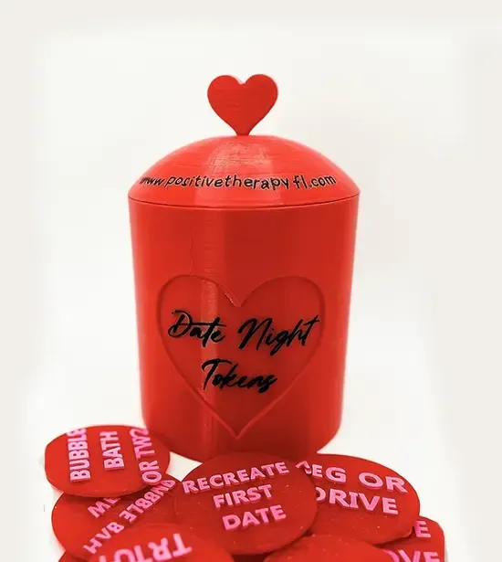 Red heart-shaped gift box with red petal-like pieces and romantic text on a white background