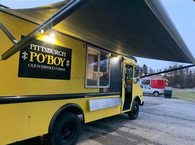 Pink food truck with red lights, advertising ice cream. 