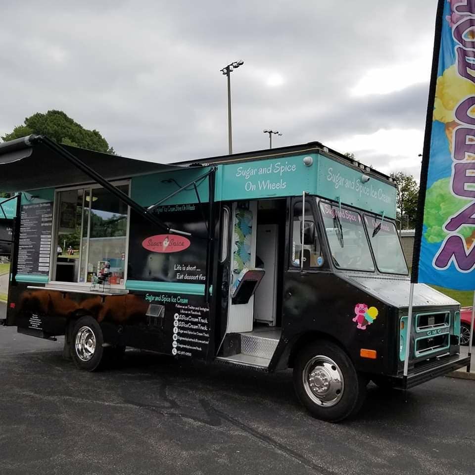 Black food truck with teal accents selling ice cream, parked on asphalt.