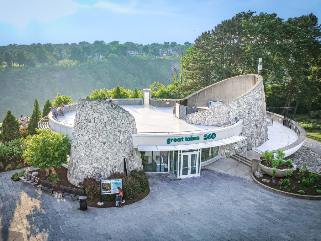 An aerial view of a large stone building with trees in the background.