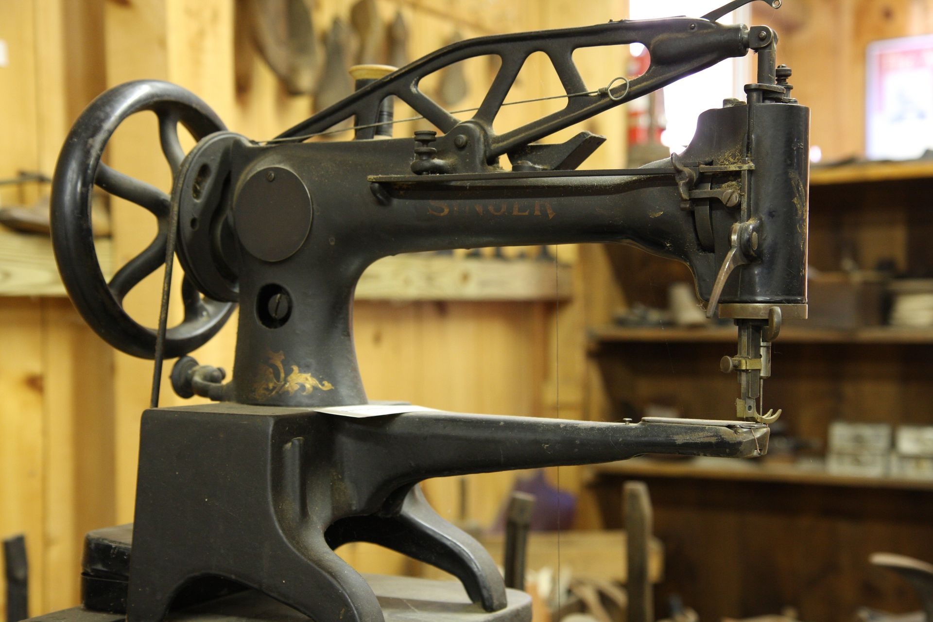 An old sewing machine is sitting in a wooden room