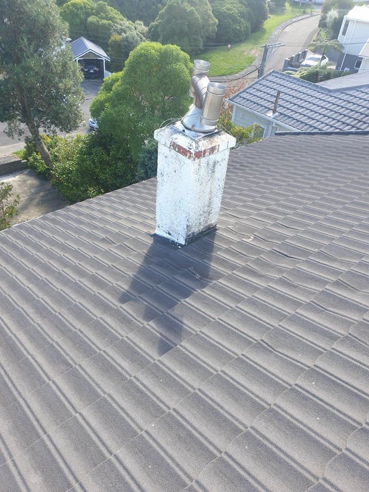 An antenna on top of a chimney with a blue sky in the background