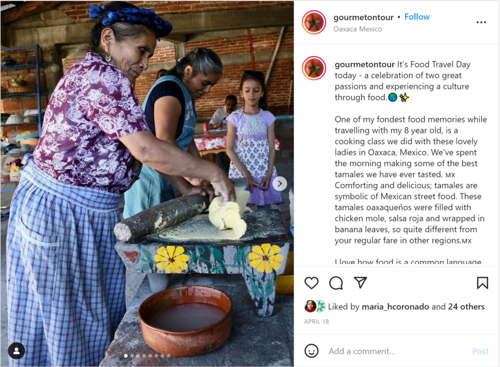 A group of women are standing around a table preparing food.